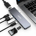 Silver aluminium USB-C multi-port adapter hub with SD card slot, HDMI, USB ports, and Power Delivery.