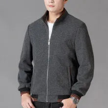 Men's grey polyester fleece jacket with long sleeves and a stick pocket, shown on a hanger.