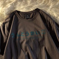 Loose fit black cotton t-shirt with white printed letter design on the chest.