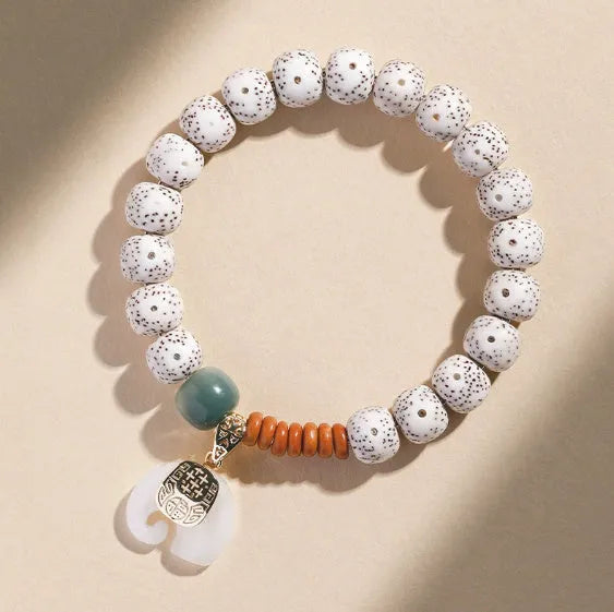 Jade green star moon bodhi bracelet with 10mm geometric beads on white background