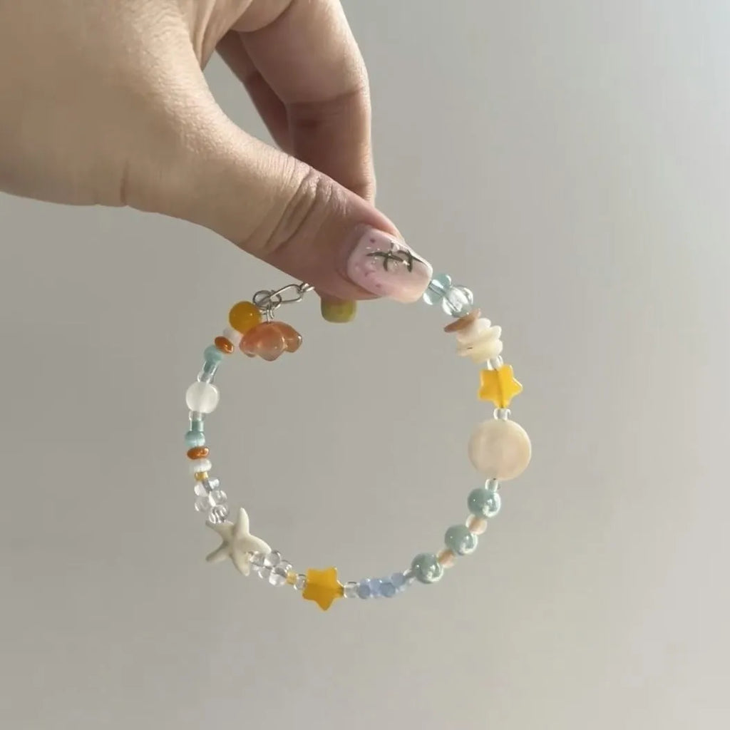 Orange alloy bracelet with diamond-shaped links and round decorative elements for women