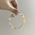Orange alloy bracelet with diamond-shaped links and round decorative elements for women