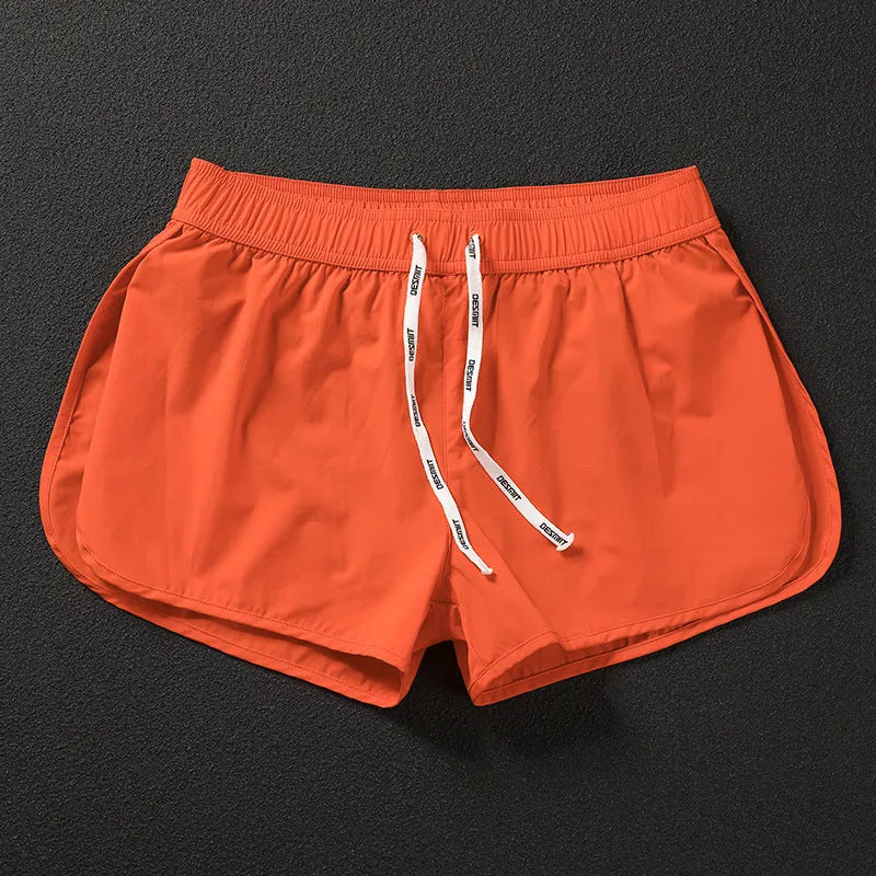 Men's loose-fit polyester surfing trousers in black, fluorescent green, and orange red colours