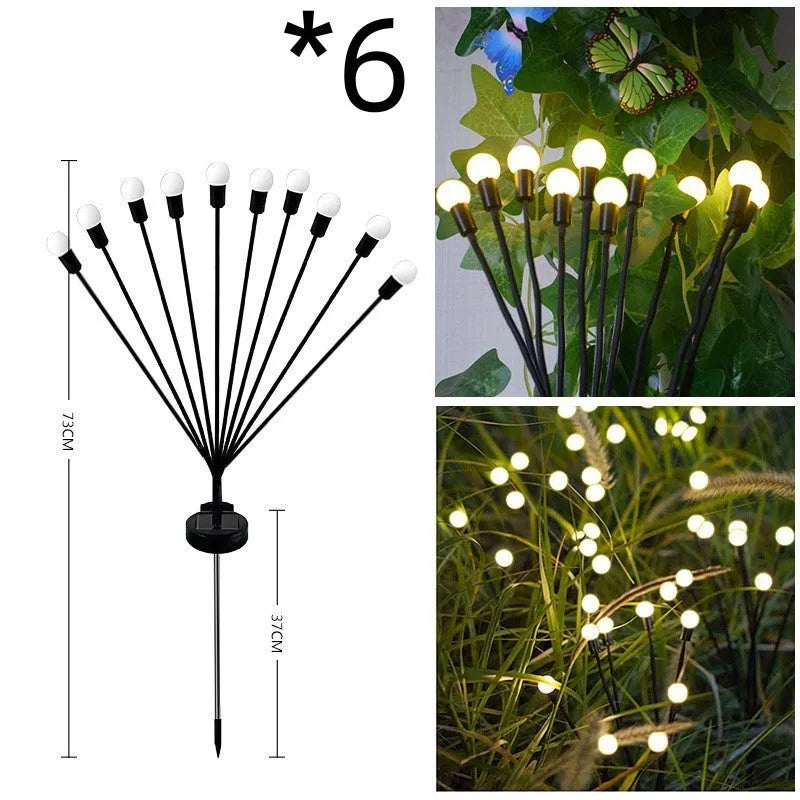 Solar-powered LED firefly lawn light with ground stake inserted in grass