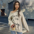 Woman wearing a light khaki Alpaca wool pullover sweater with an oblique zip and turtleneck.