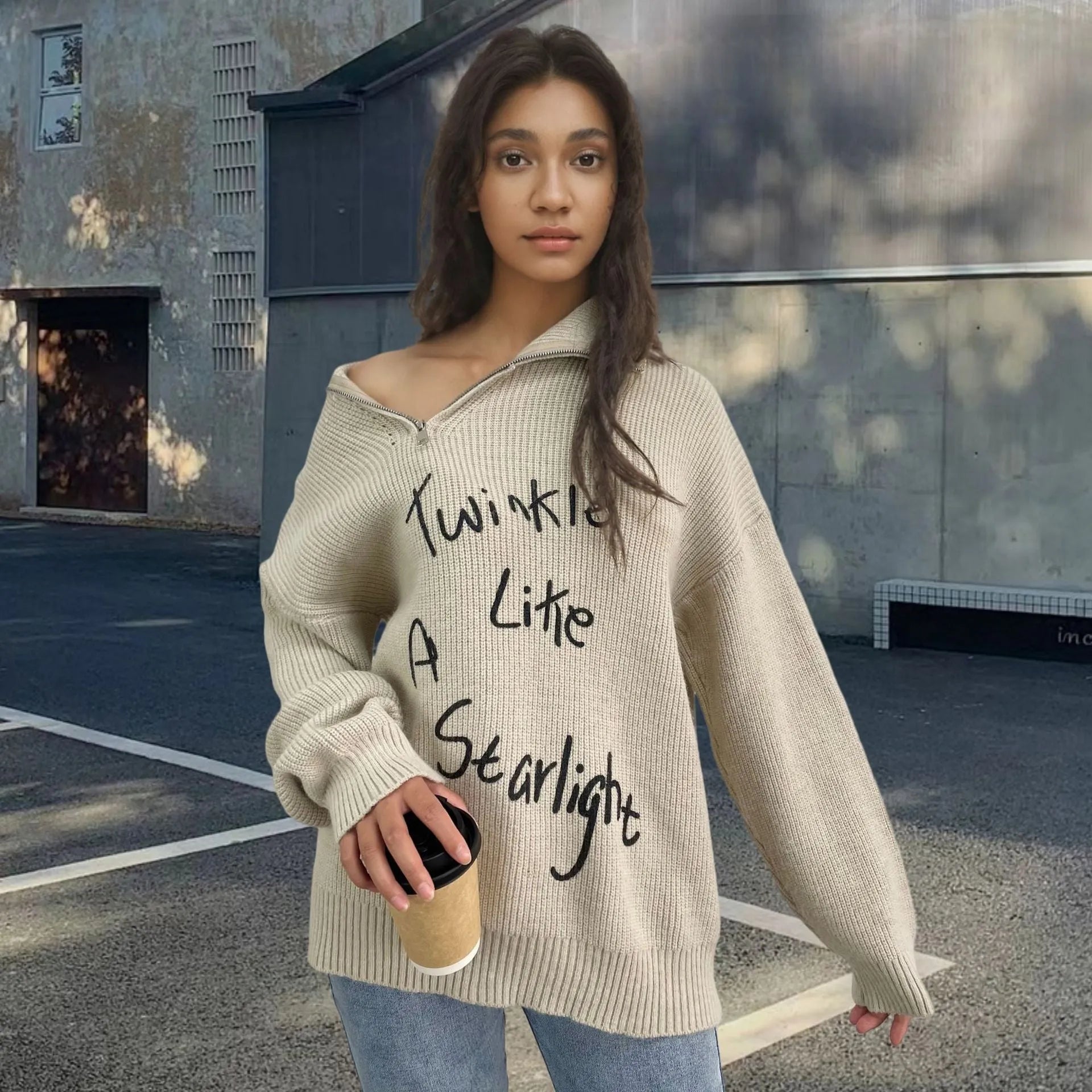 Woman wearing a light khaki Alpaca wool pullover sweater with an oblique zip and turtleneck.