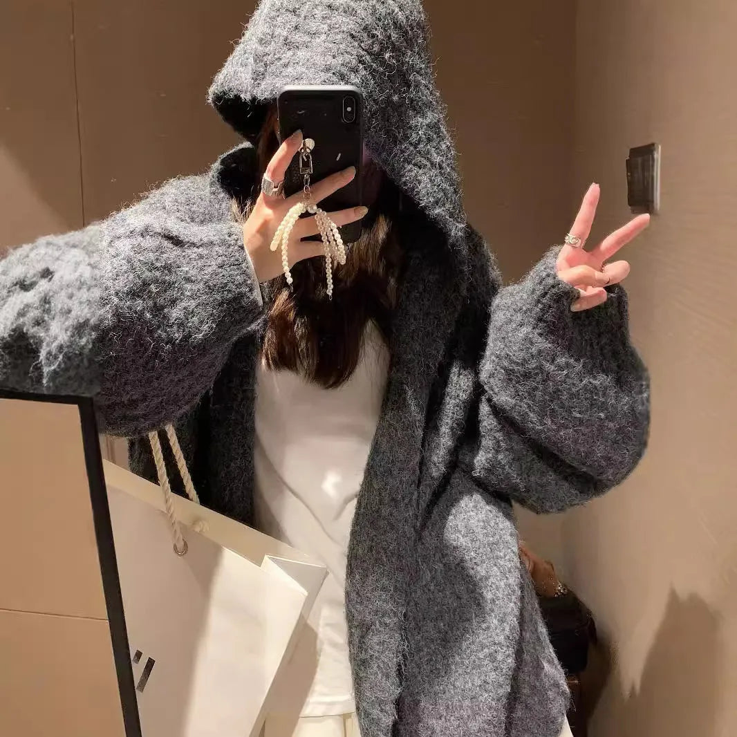 Women's loose hooded cardigan in thick acrylic blend, shown in dark grey, brown, and milky white.