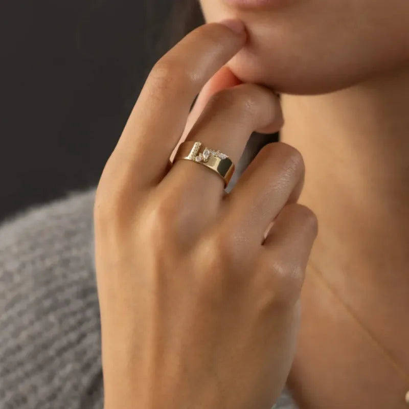 Gold-plated copper ring with shining zircon stones on a white background