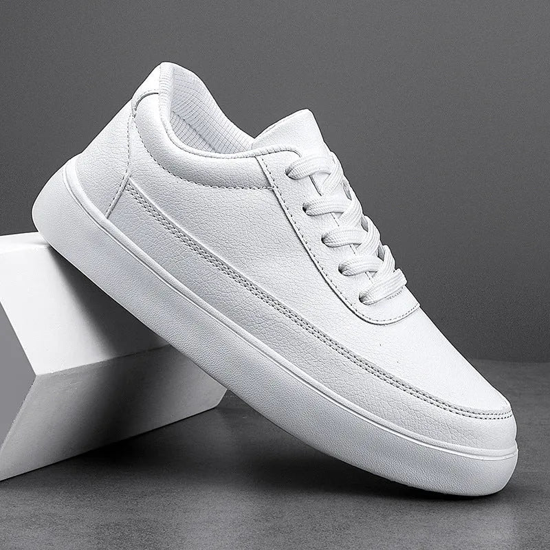 Women's white leather casual flat lace-up shoes on a neutral background.