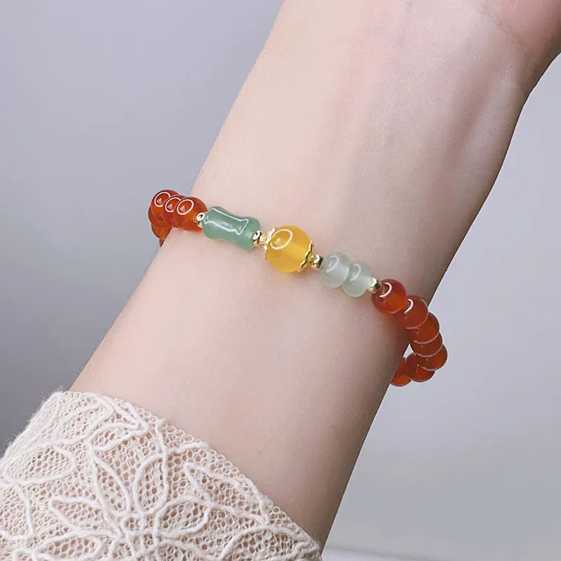 Handmade red agate bracelet with dragon and lucky bag Chinese designs for women.