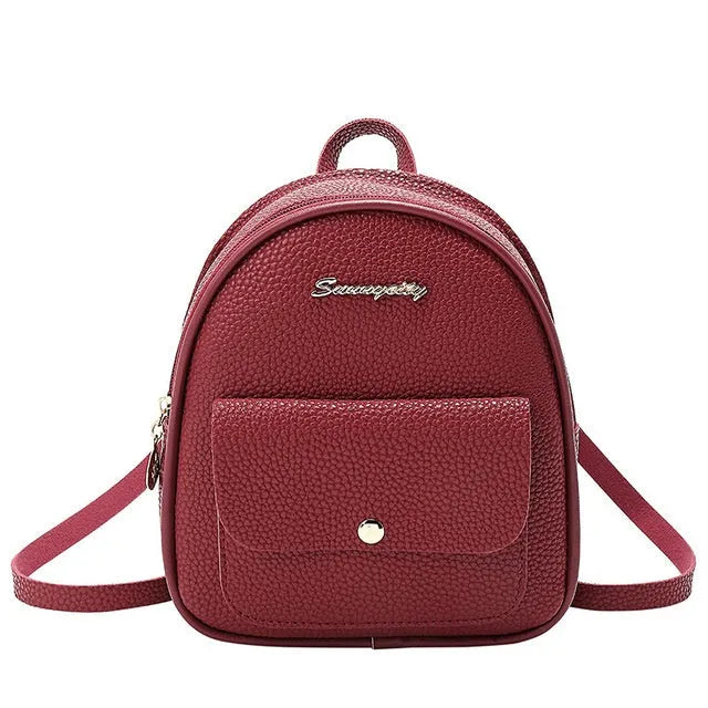 Women's small black PU leather backpack shoulder bag showing front zipper and dimensions