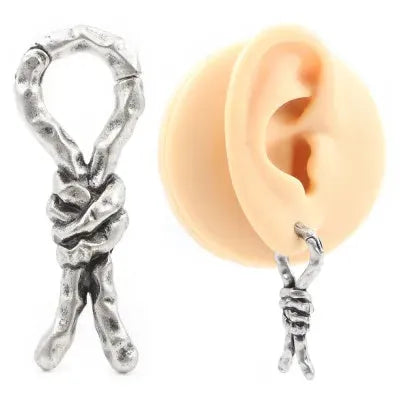 Close-up of a 4mm copper piercing earring with a bending, connecting retro shape.
