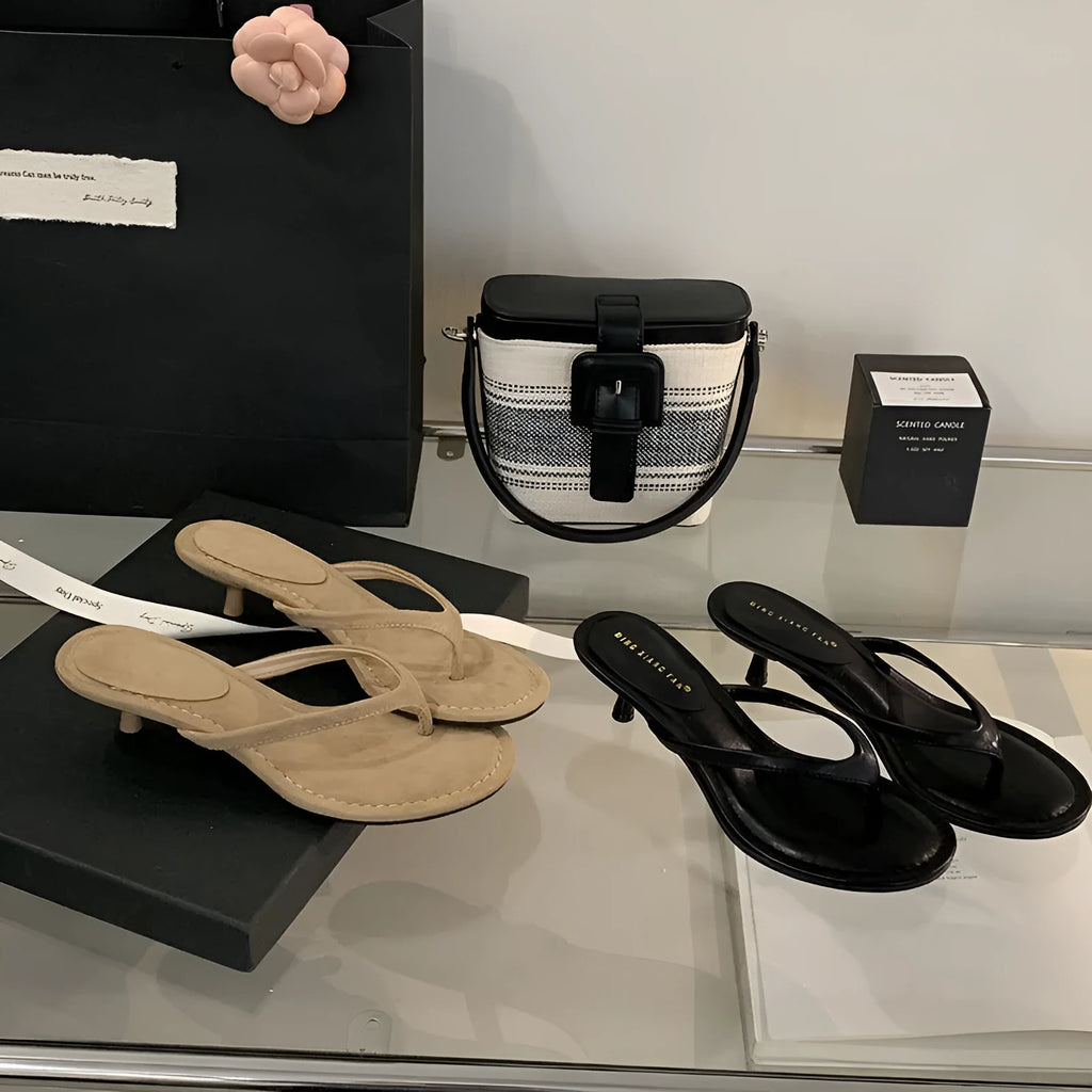 Women's rubber stiletto flip-flop sandals in black and camel colours on a white background.