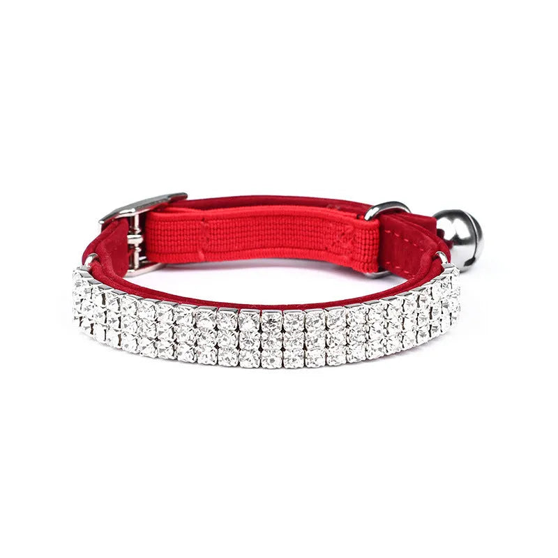 Adjustable red velvet cat collar with rhinestone details on a suede strip.