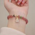 Geometric Strawberry Quartz women's bracelet with a lucky Bagg charm and a silver safety buckle clasp.