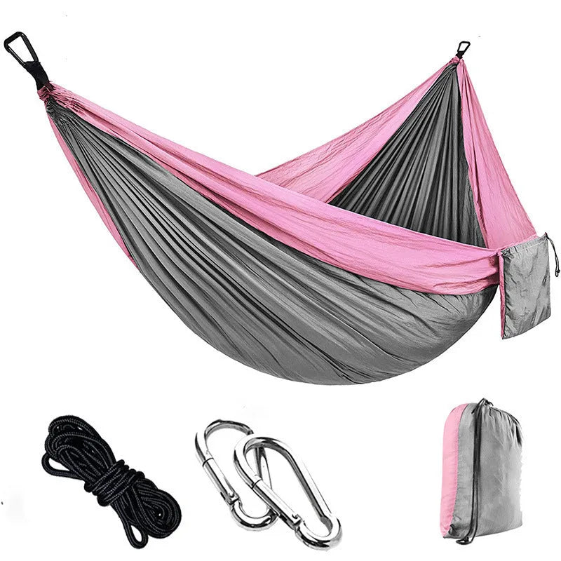 Double camping hammock with ropes and buckles shown in outdoor setting