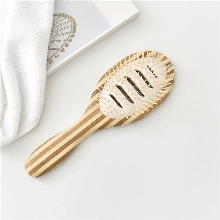 Natural bamboo scalp massage comb with round nylon teeth and rubber pad on neutral background
