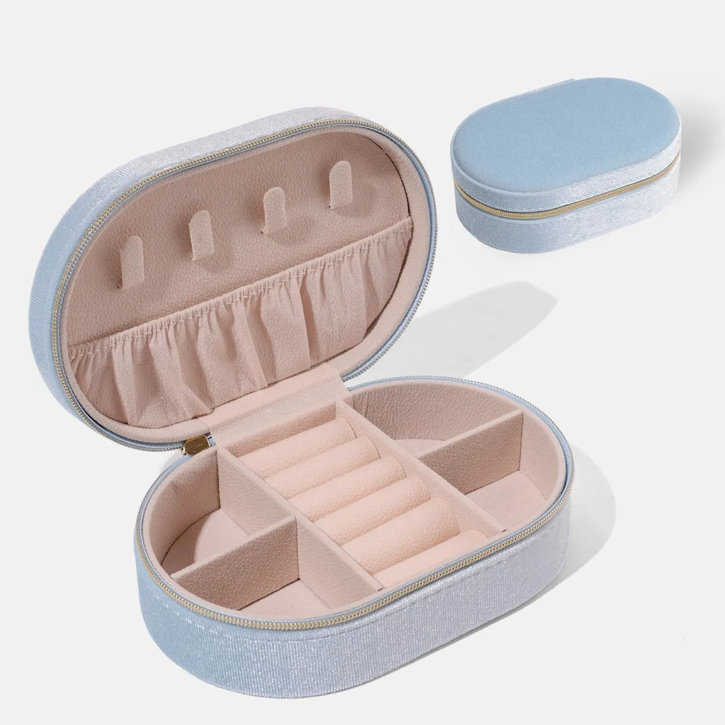 Oval velvet jewellery storage box in lake blue colour with flannel lining, shown with internal hook