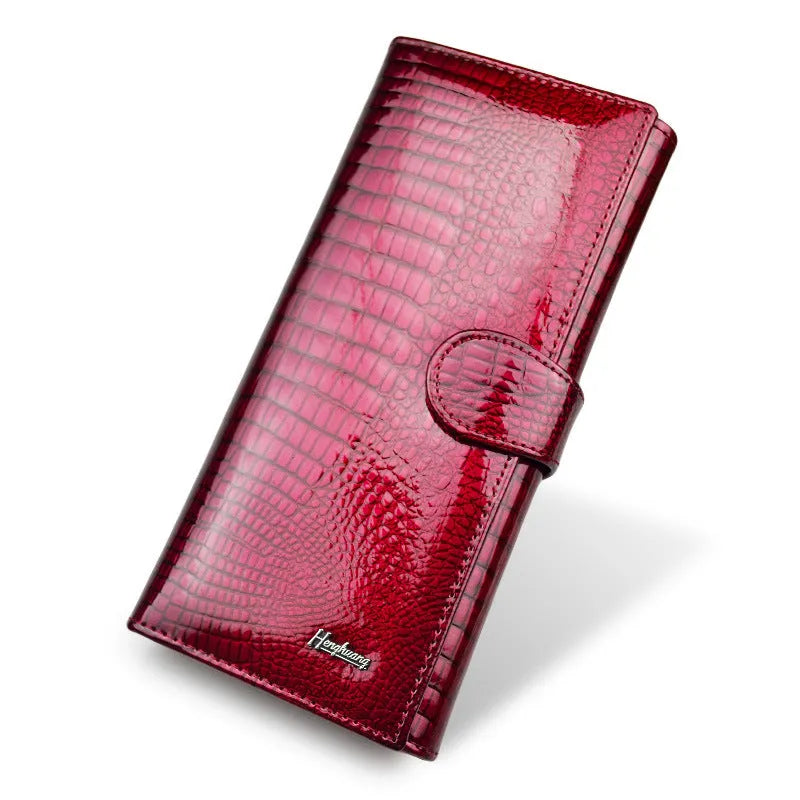 Genuine leather coin purse with patent finish and crocodile pattern in wine red colour