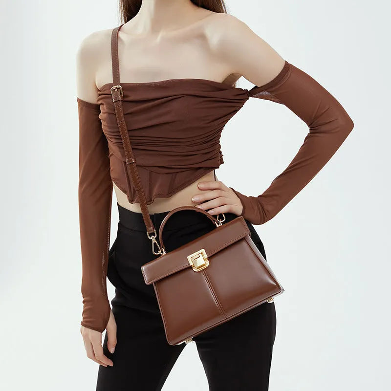 Women's genuine leather shoulder bag with vachette clasp in horizontal square design showing internal compartments