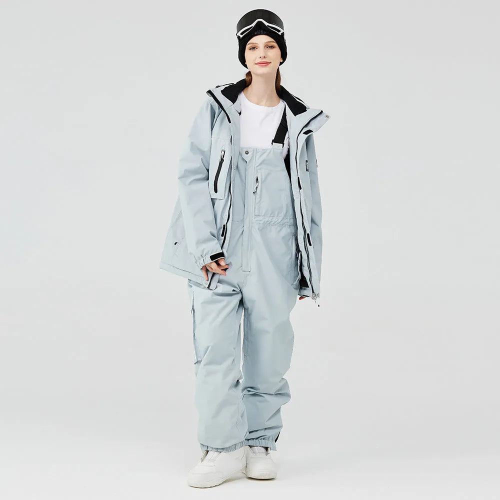 Men's and women's waterproof winter ski suit in blue top with grey blue trousers.