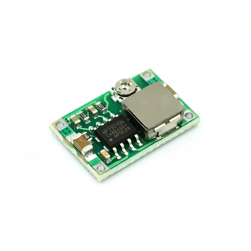 Mini-360 green DC-DC buck converter step down power supply module on white background