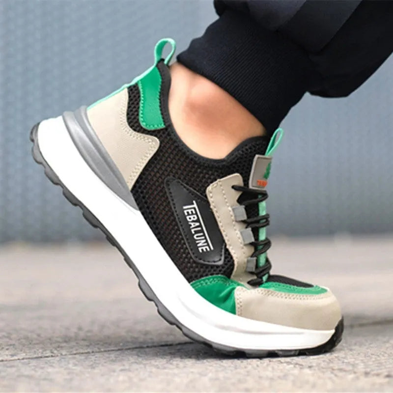 Black and green low-top safety shoe with mesh upper and plastic steel toe cap on a white background.