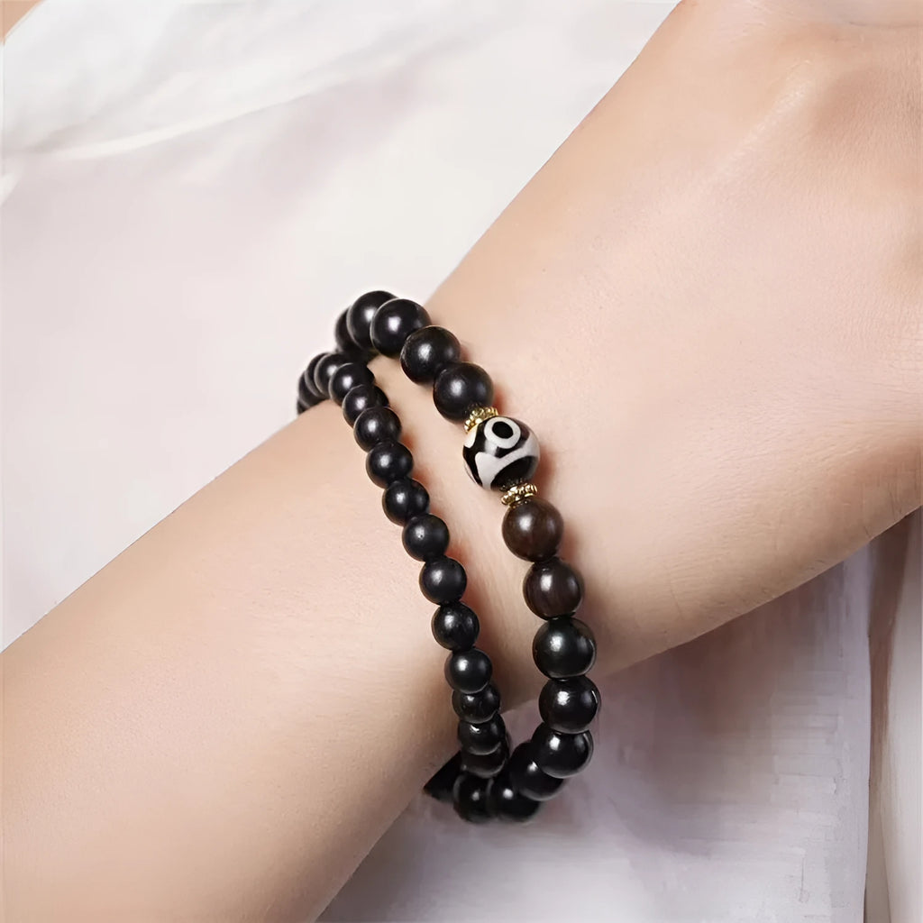 Solid ebony wood bracelet with 8mm Tibetan beads showing two-circle pattern