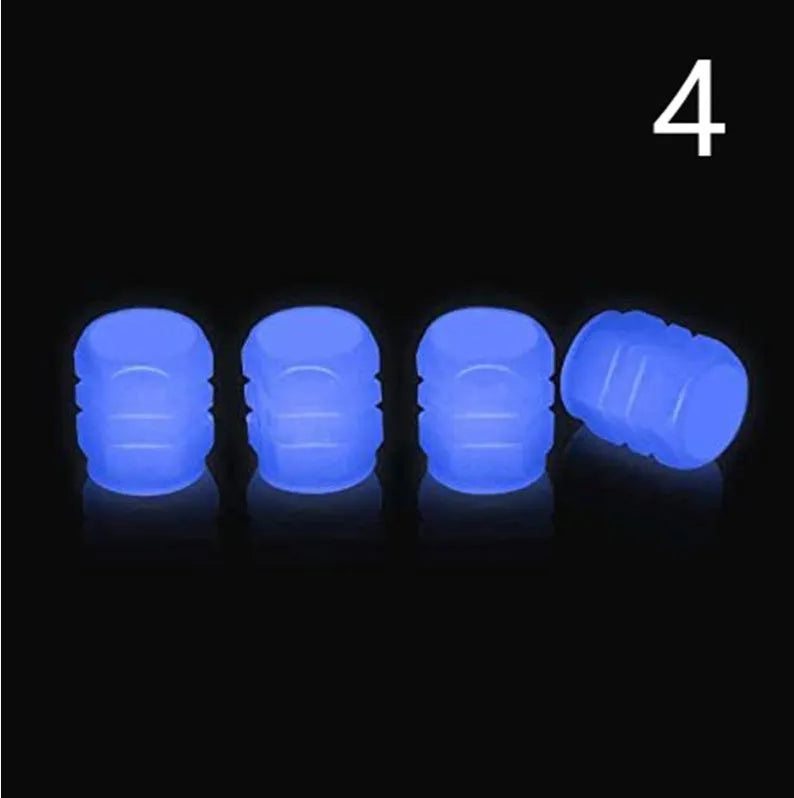 Pack of green and blue luminous rubber tyre valve caps on a car tyre valve.