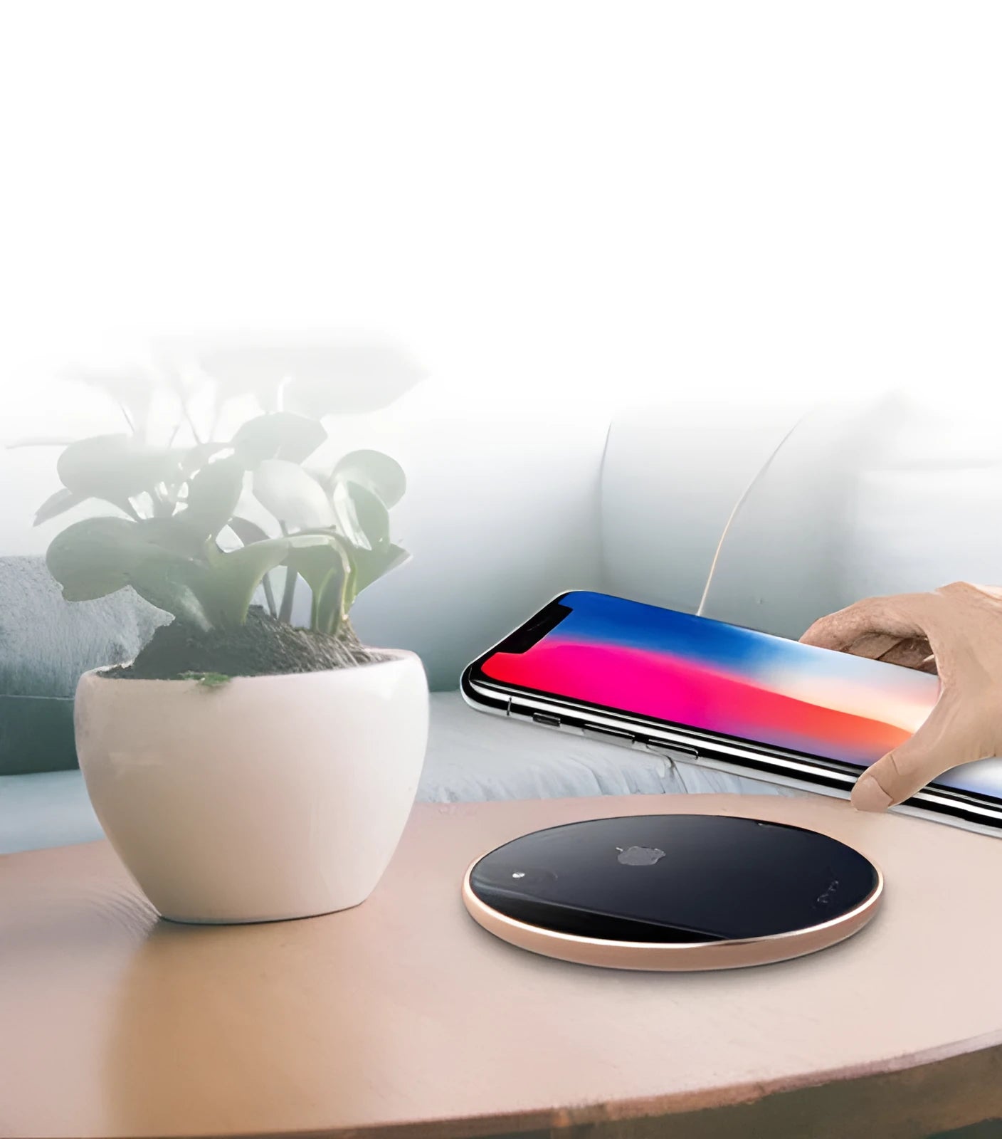 Slim aluminium wireless charging pad in rose gold colour on a wooden surface