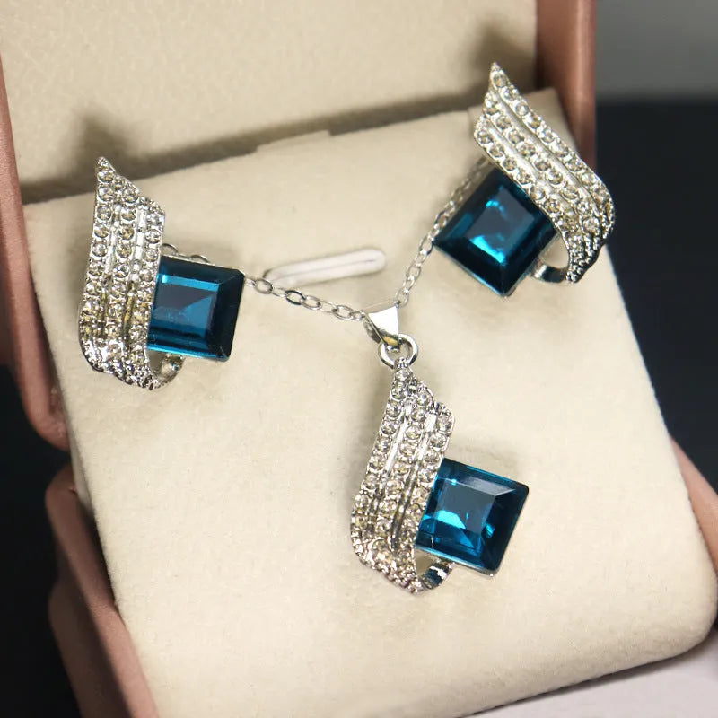 Electroplated alloy necklace and earring set with glass pendant and cross chain design