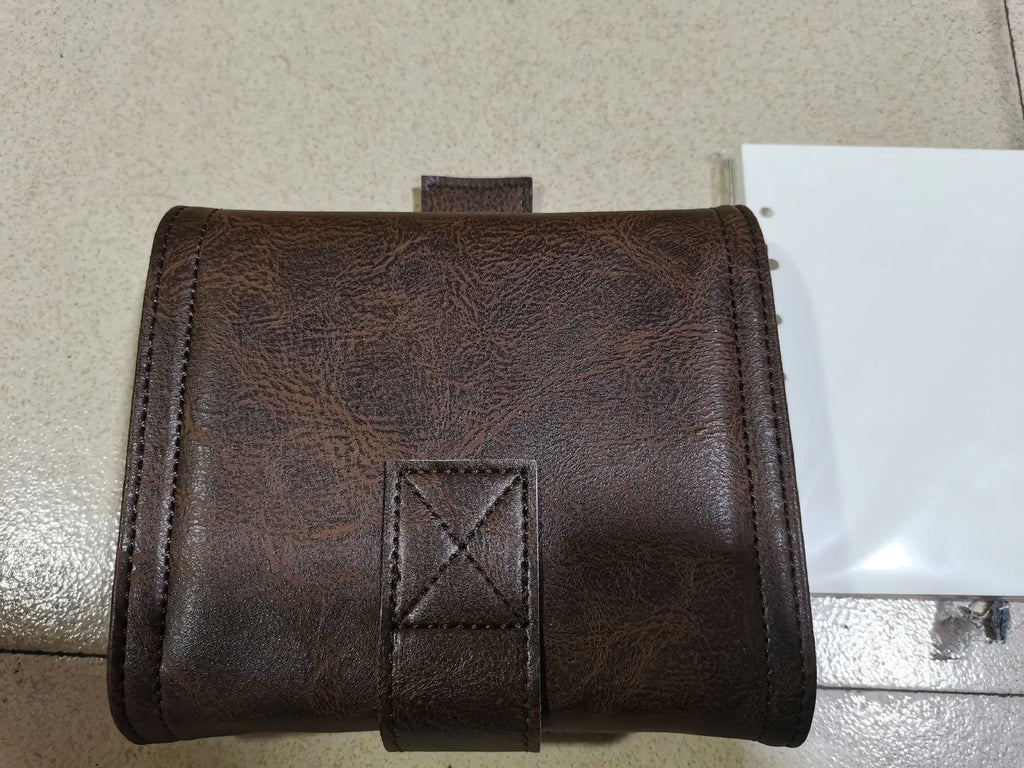 Brown PU cover A7 notebook with metal buckle closure showing loose-leaf binding and raw wood pulp pages