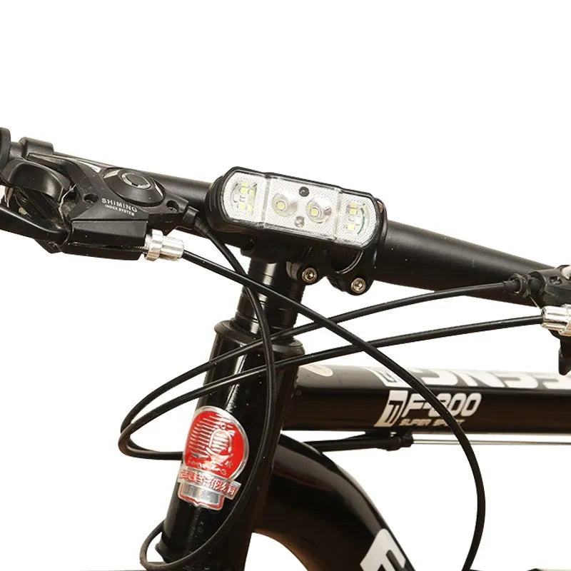 Black bicycle headlight with LED, showing mounting bracket and rechargeable battery.