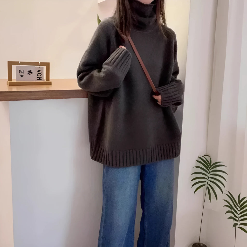 Women's thick loose-fit turtleneck sweater with curling pile collar in red, camel, grey, or black.