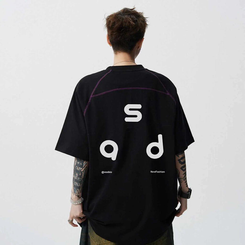 Man wearing a loose-fit black cotton t-shirt with a white letter print on the chest.