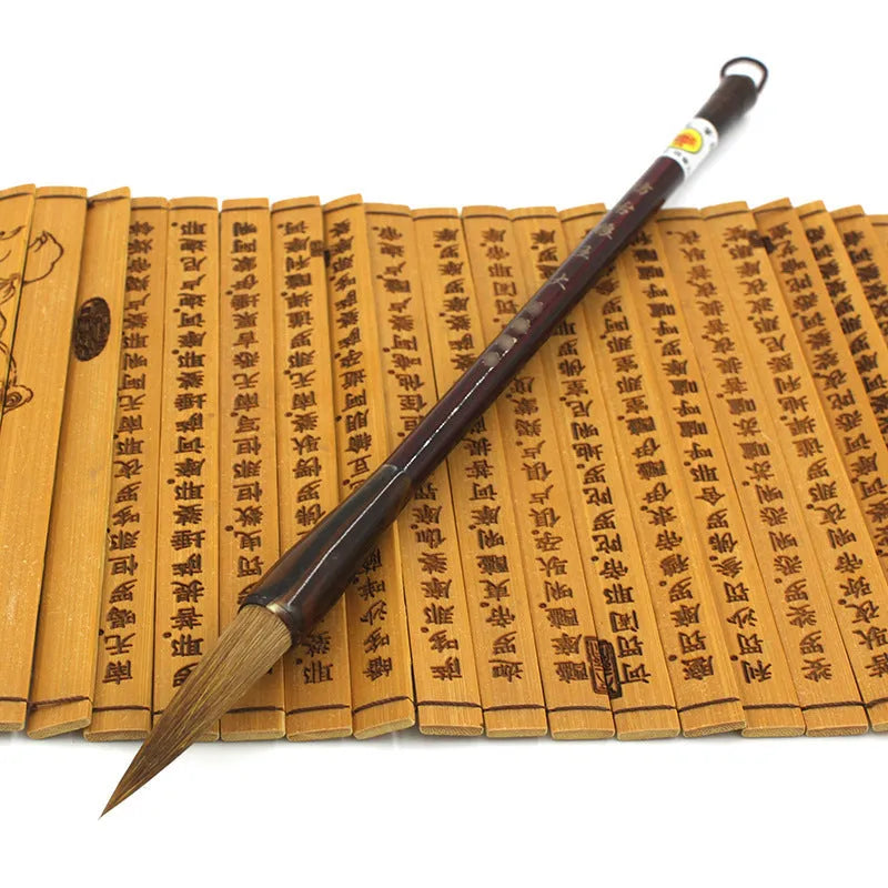 Traditional Chinese wolf hair calligraphy brush with steel rod, shown in large, medium, and small sizes.