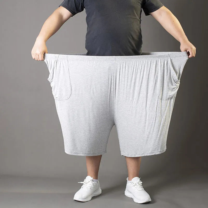 Plus-sized man wearing black loose fit modal sports trousers
