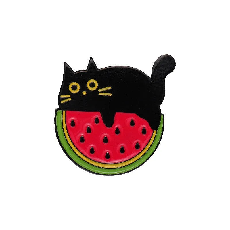 Colourful cartoon fruit design metal brooch with pin back on a fabric background.