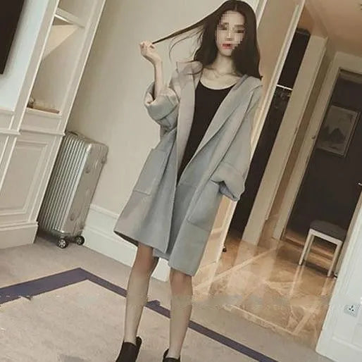 Plus size woman modelling a loose grey cotton coat with lace details for spring or autumn.