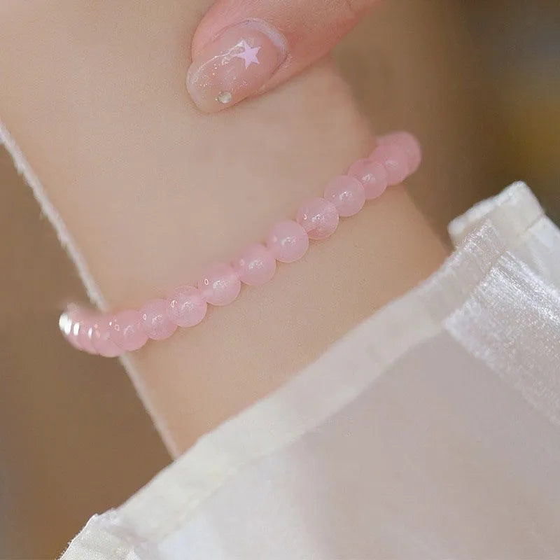 Aquamarine crystal bracelet with mixed materials including pink beads, white pearls, and peach blossom elements