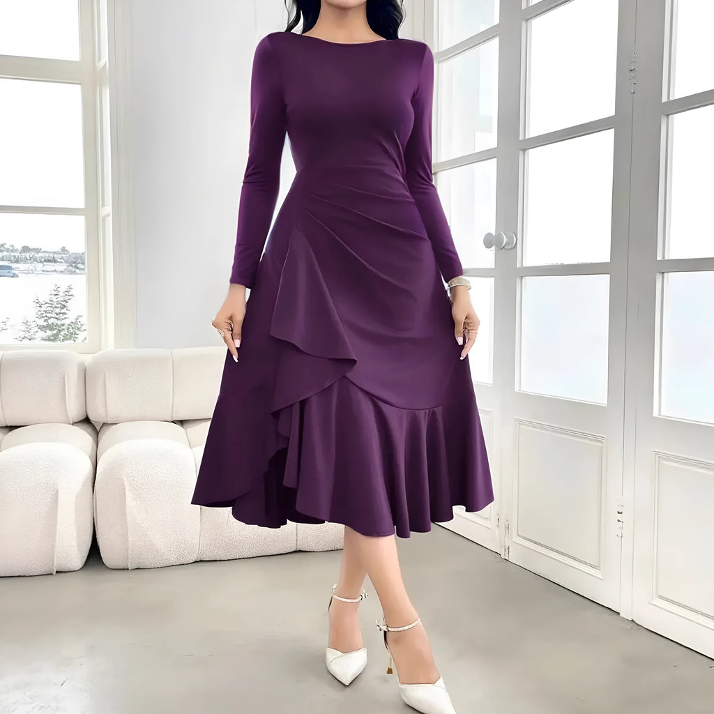 Purple women's long sleeve dress with ruffles, a round neck, and a mid waist fit on a hanger.