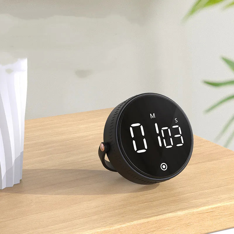 Black digital kitchen timer with rotary dial and LED display showing minutes and seconds