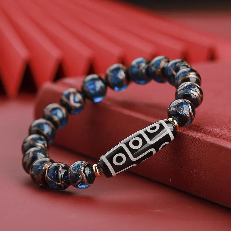 Close-up of a coloured glaze bracelet with traditional Chinese snake design and multi-coloured beads.