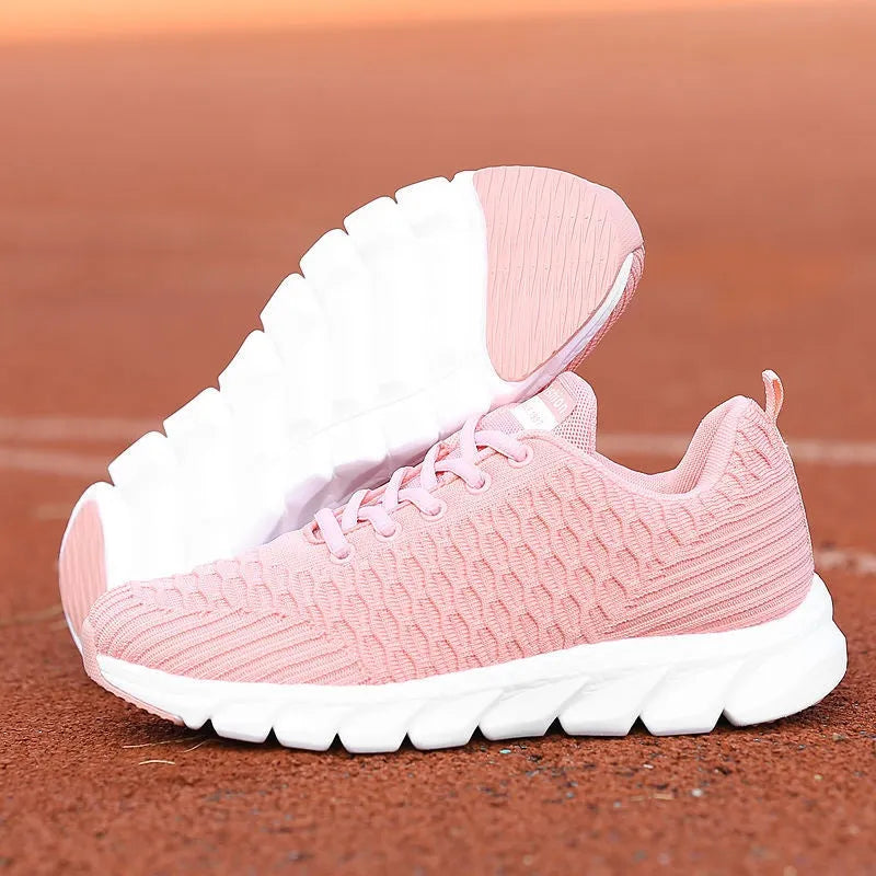 Women's running shoes with a fly weave upper in black, pink, and white colour options on a wear-resistant outsole.