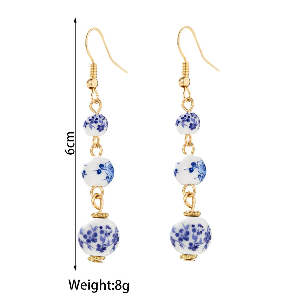 Blue and white porcelain ceramic bead long retro earrings with geometric round design and alloy electroplated finish
