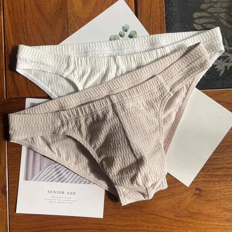 Men's solid colour cotton triangle briefs in mid-waist style, shown in apricot and black colour options.