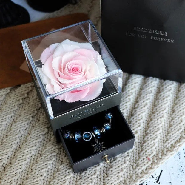 Eternal Flower gift box with preserved roses and carnations inside, measuring 8.5 cm square by 10.5 cm high