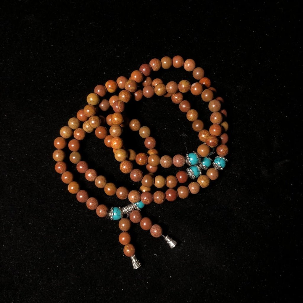 Handmade 108-bead lvzhu stone bracelet with 5-6mm geometric beads on wrist