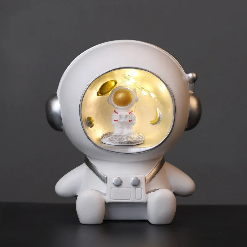 Synthetic resin cartoon spaceman night light ornament on bedroom table with battery power
