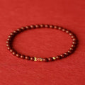 Natural cinnabar koi bracelet with golden ball charm in traditional Chinese style design